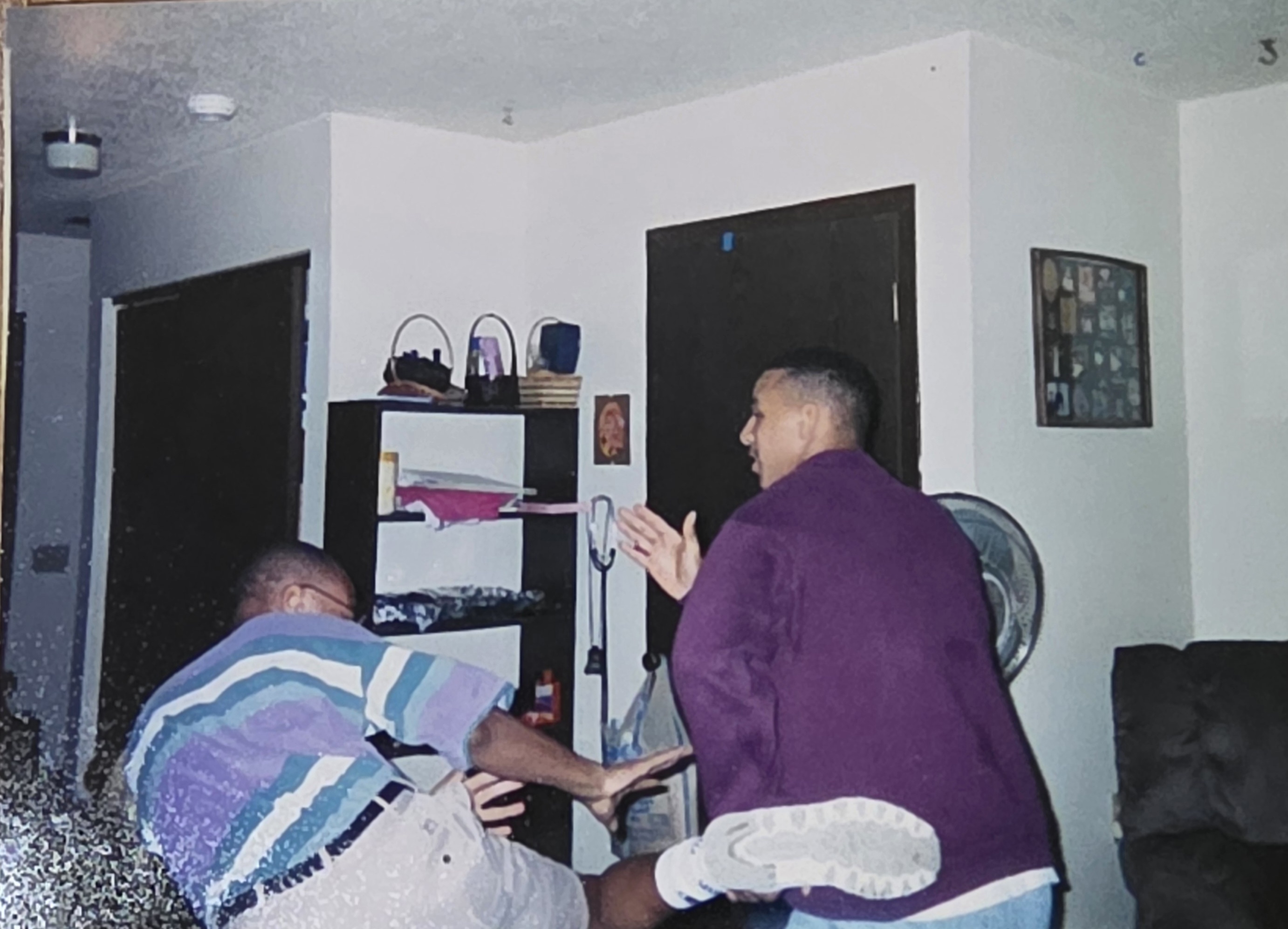 Lawyer A. Twillie II with his cousin in the Section 8 apartment during his college years, working full-time while attending law school